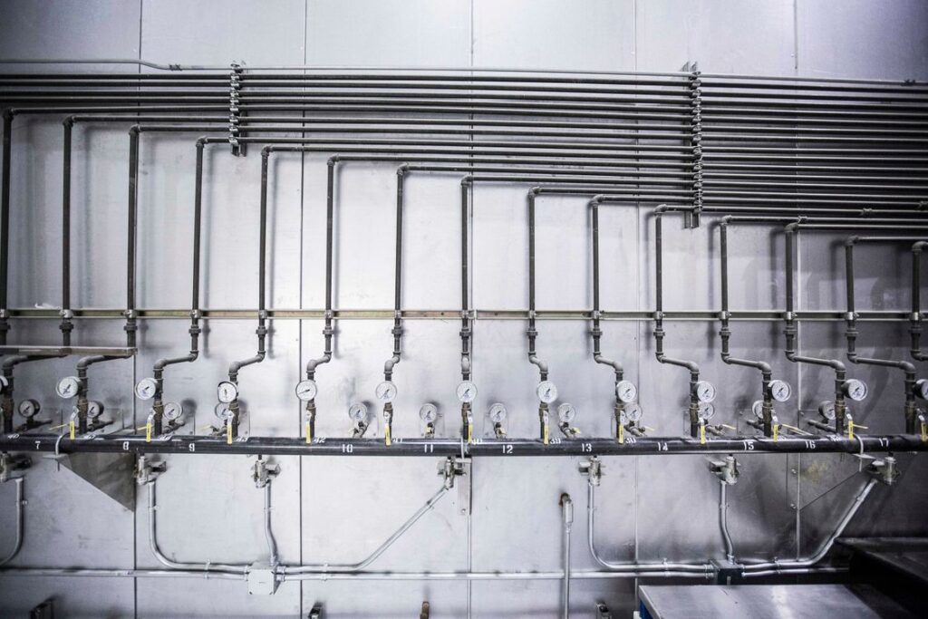 Industrial gas manifold with a row of pressure gauges
