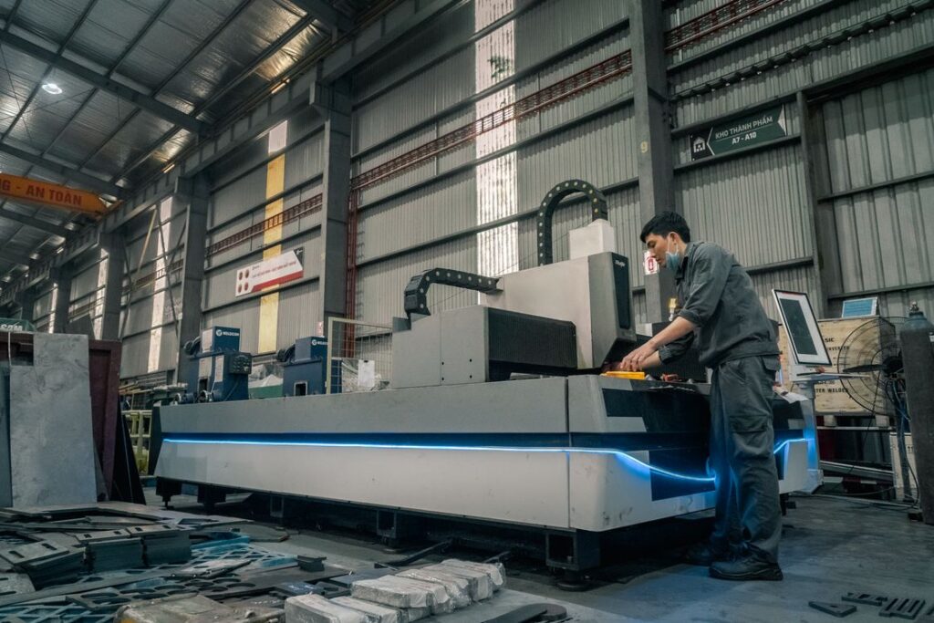 Operator at a modern fiber laser cutting machine in a shop