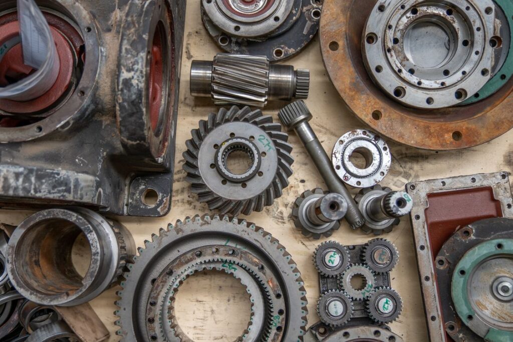 Industrial gears and machine spare parts laid out on a workbench