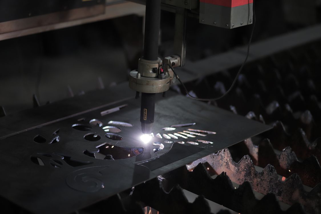 Laser cut edge quality being produced as a cutting head slices metal