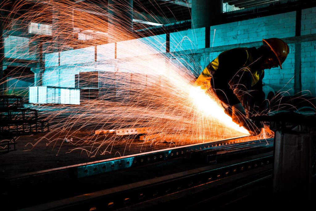 Sparks fly during metal cutting in a fabrication shop, the precision work Tanaka laser cutting machines deliver