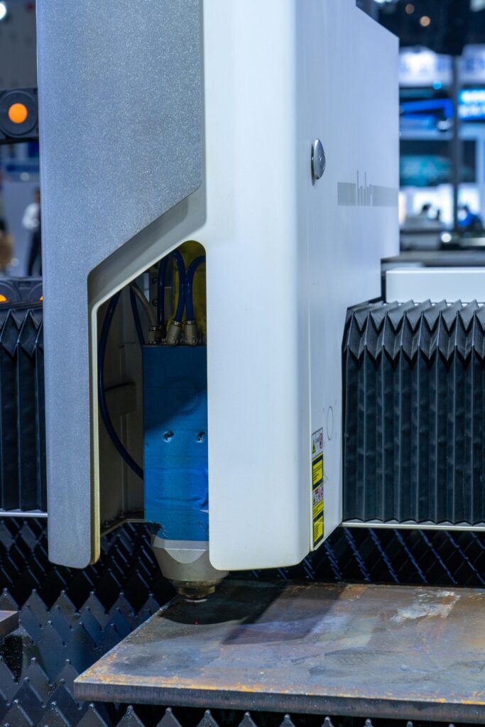 Industrial laser cutting machine in operation, where a weak resonator shows up first as slower cutting and inconsistent edges