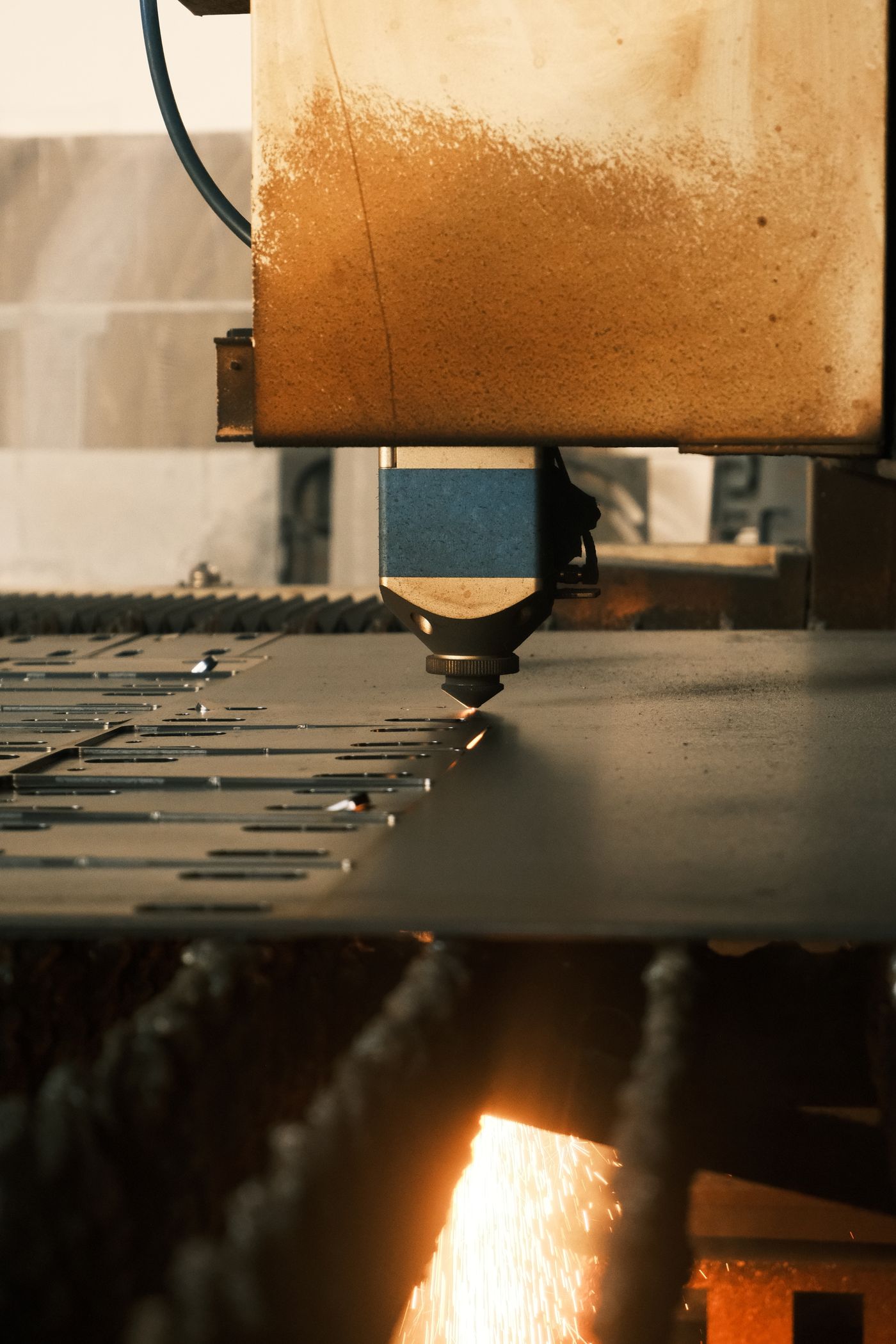 Laser cutter operating in a factory, the investment behind the new versus used laser cutting machine decision