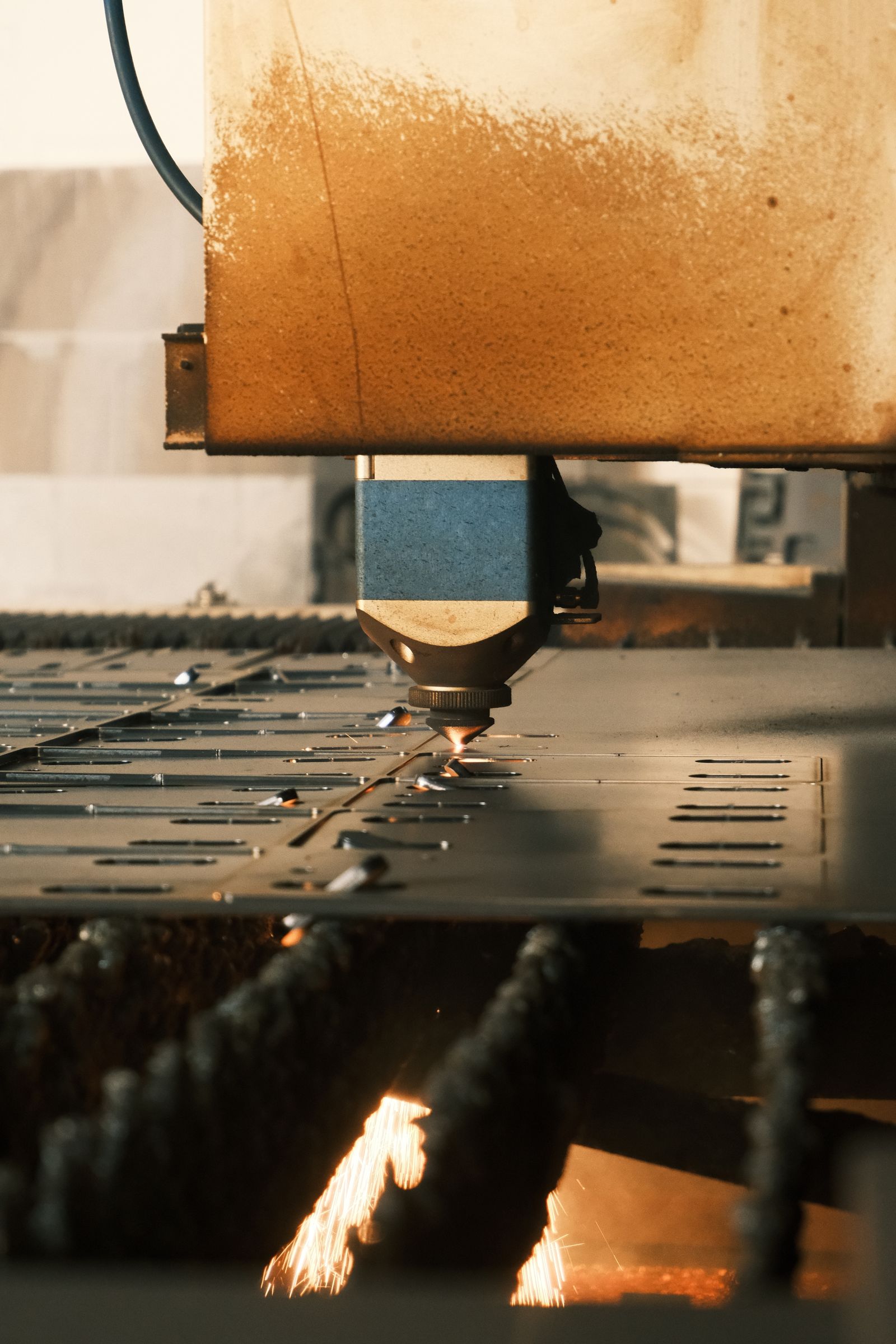 Laser cutting galvanized steel sheet on a flatbed fiber laser in a fabrication shop